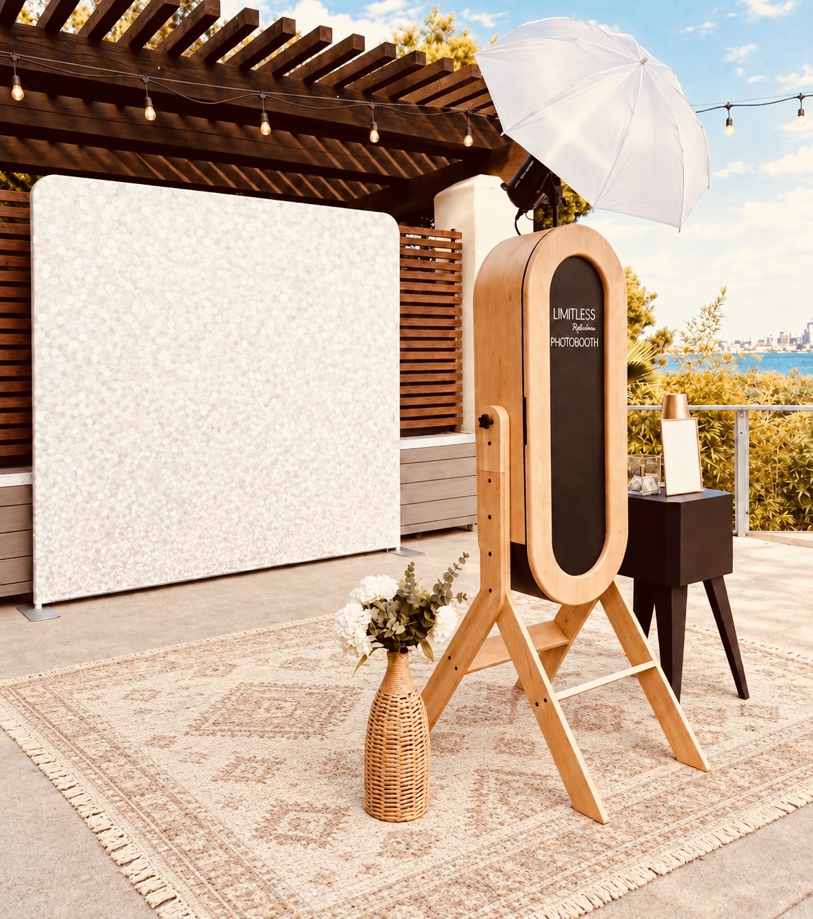 Wooden mirror photobooth with a white backdrop at an outdoor venue
